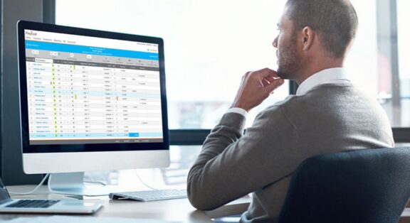 Man working at desktop computer on a Paycor interface