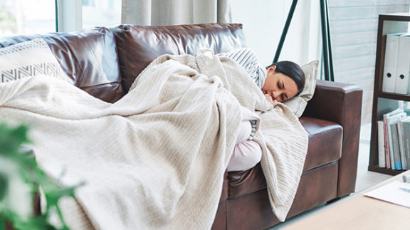 woman with covid sick on couch