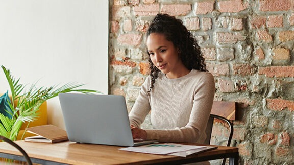 woman sitting at laptop working