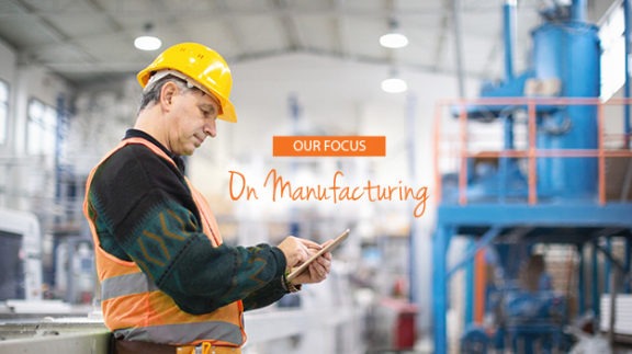 professional manufacturing worker checking tablet