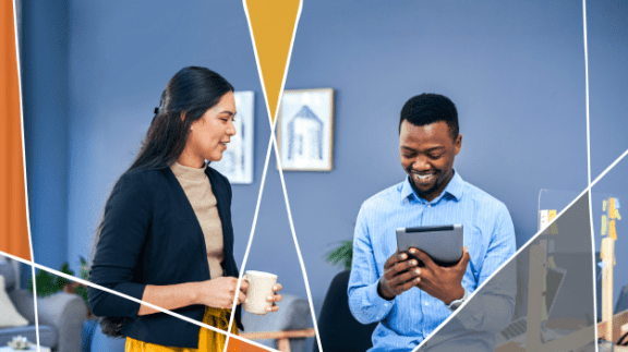 two workplace professionals standing together smiling