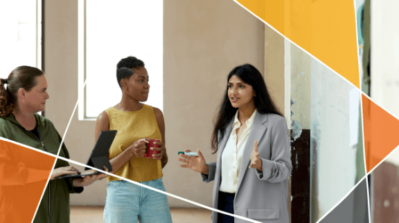 three women standing in a group talking