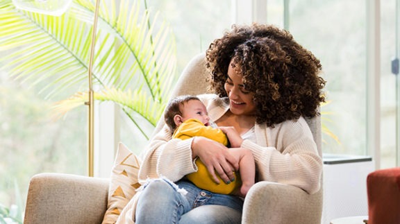 mother sitting in chair with baby