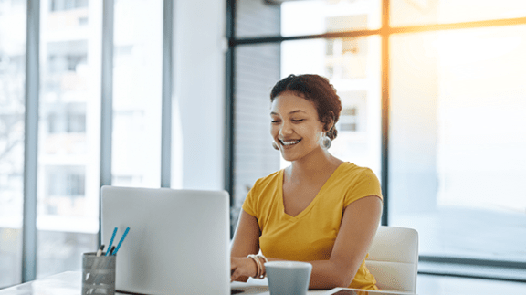 smiling woman in office using computer