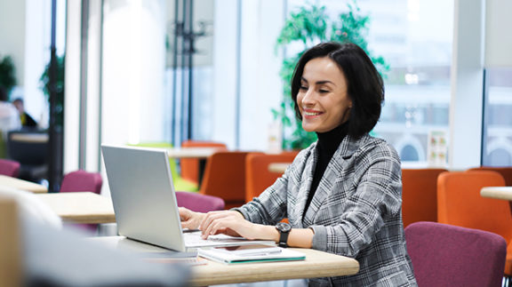 office-worker-smiling-at-laptop