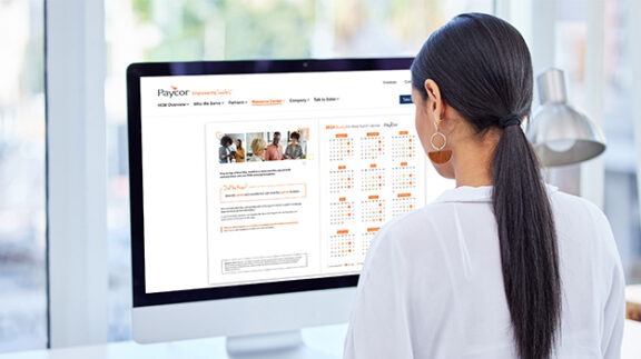 view over woman's shoulder looking at computer screen