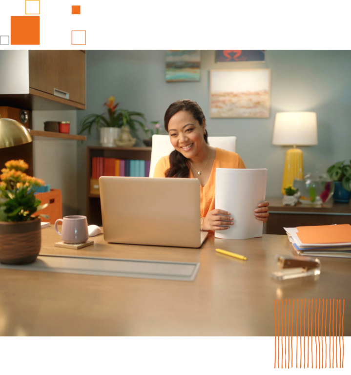 smiling woman sitting at desk