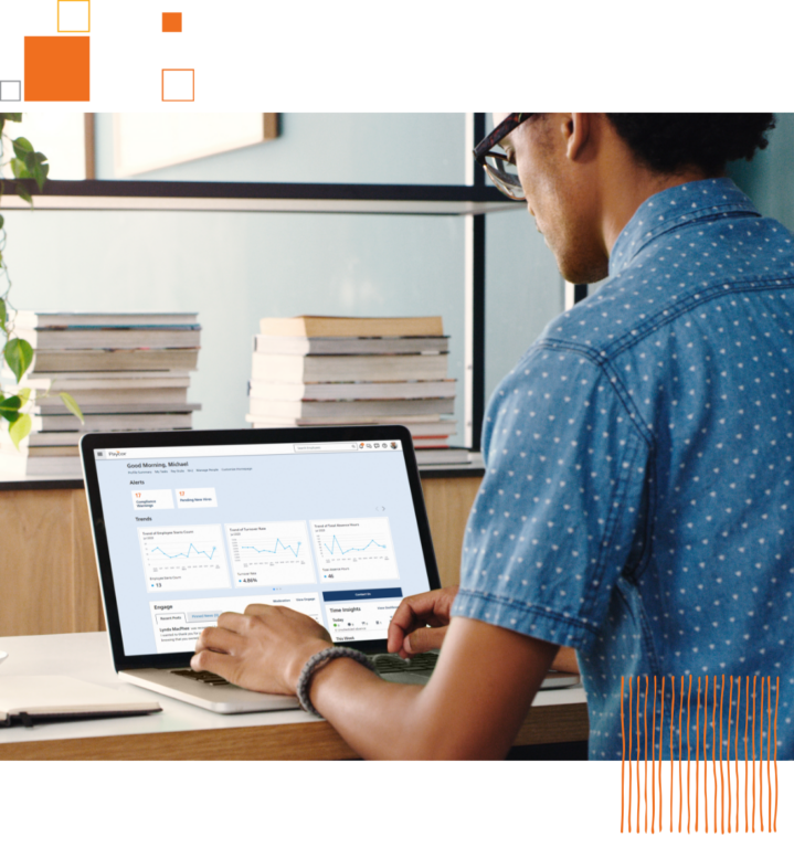 over shoulder view of laptop being used by man sitting at desk