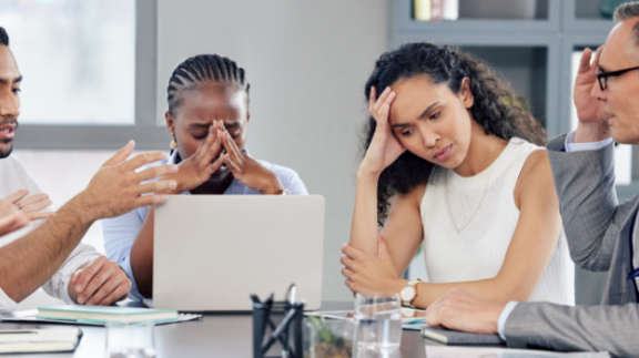 stressed employees looking at a computer