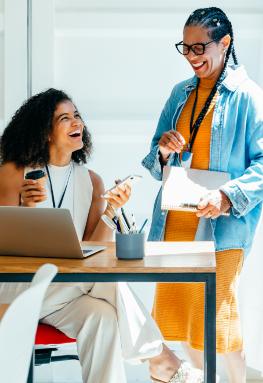 two happy women in an office